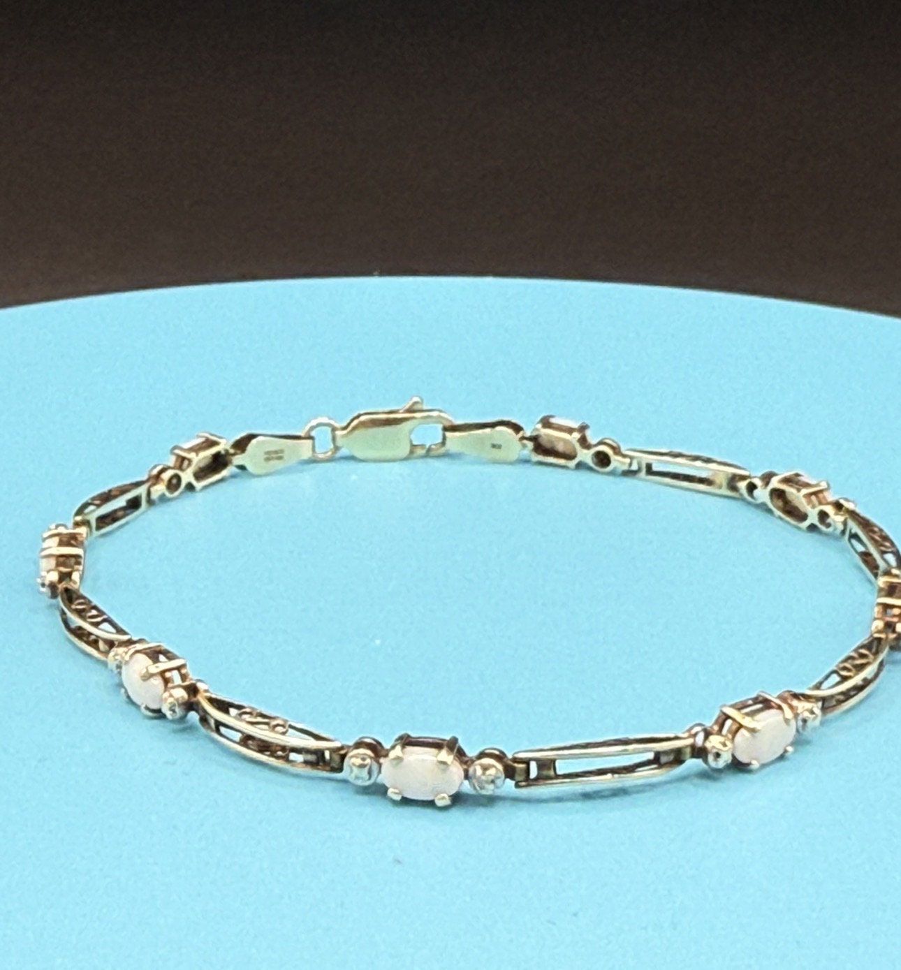 Gold link bracelet with oval opals and accent diamonds