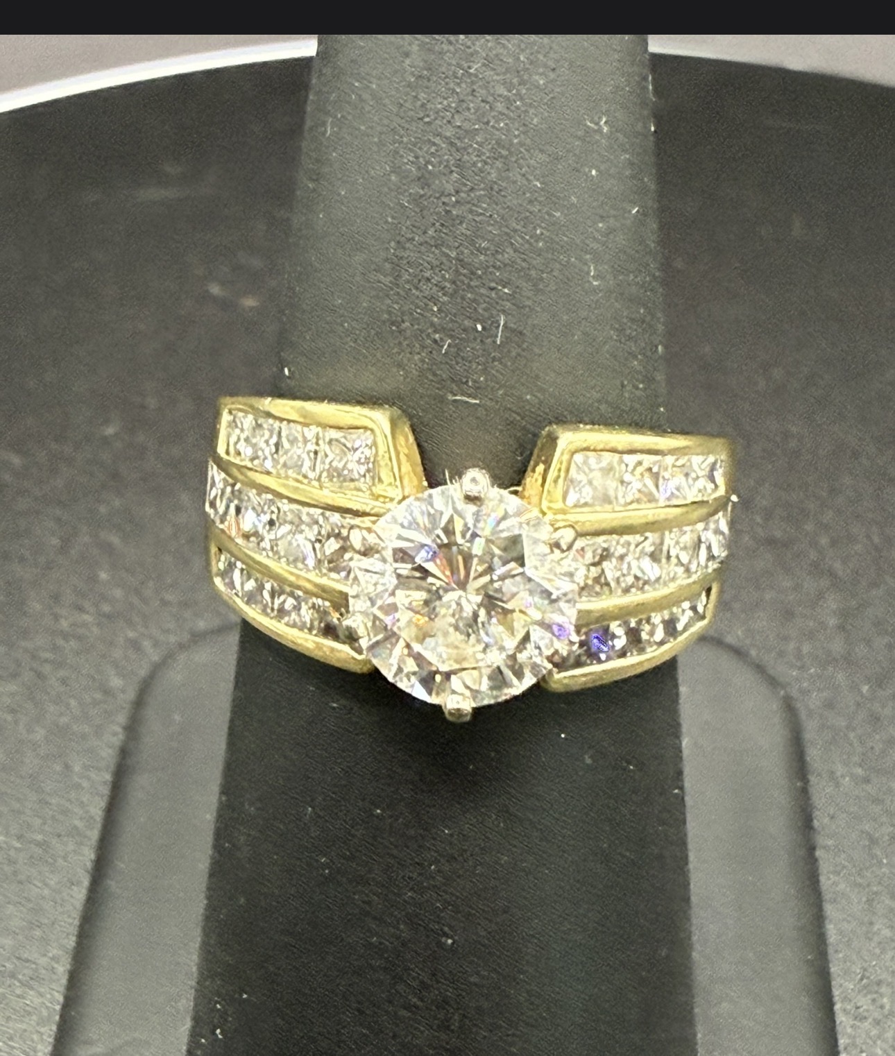 Gold brilliant diamond engagement ring with pavé shoulders