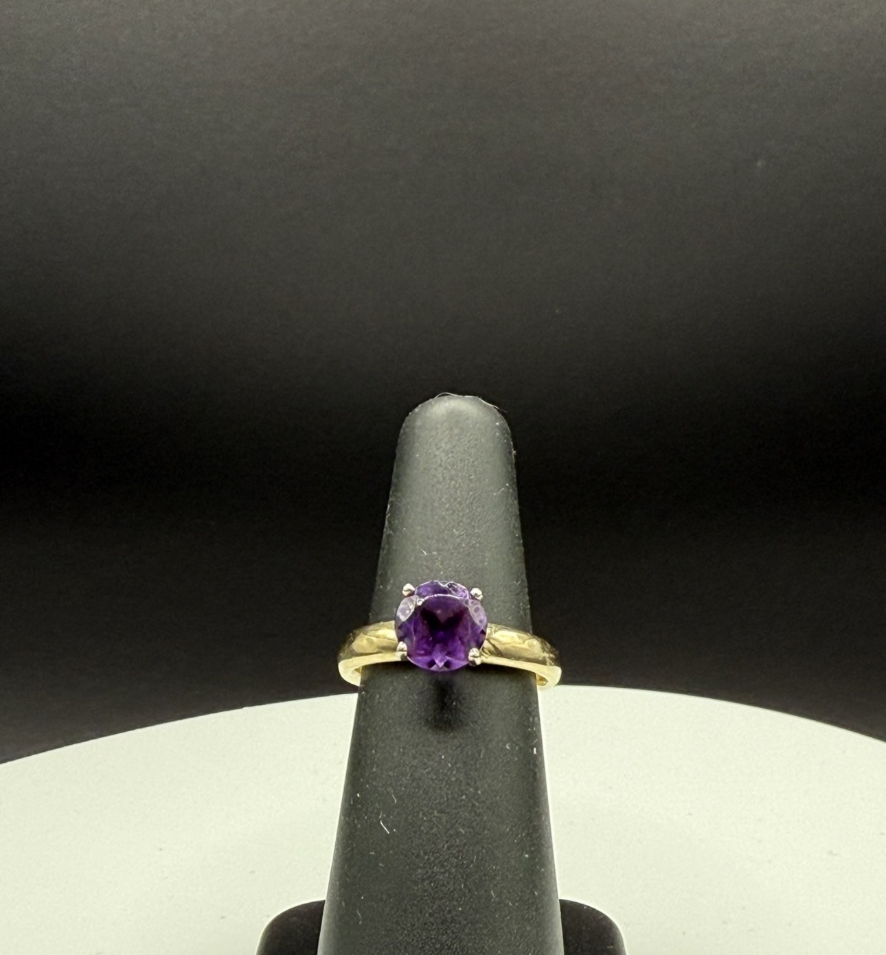 Round amethyst solitaire ring in yellow gold
