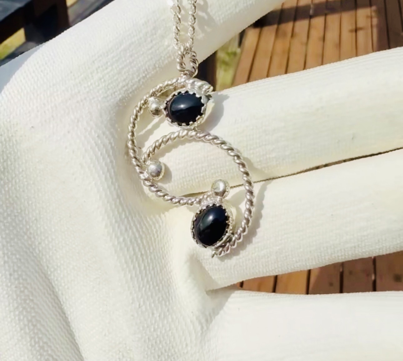Silver pendant with two black onyx stones and twisted wire